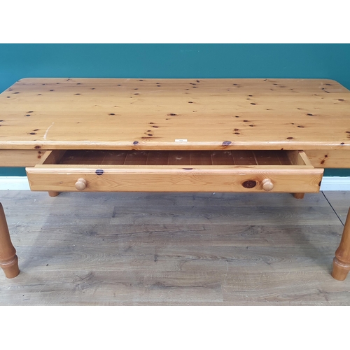 480 - A modern orange pine Kitchen Table with single fitted drawer raised on turned supports, 30