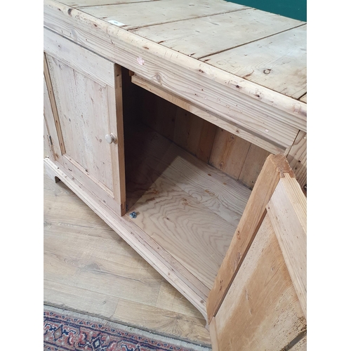 486 - A rustic stripped pine Cupboard with pair of panel doors, one end fitted with single drawer, the oth... 