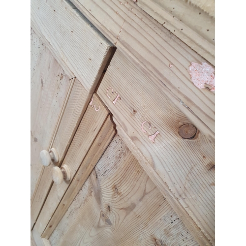 486 - A rustic stripped pine Cupboard with pair of panel doors, one end fitted with single drawer, the oth... 