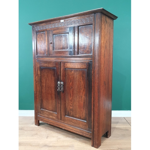 49 - An oak Cupboard fitted small door above a pair of cupboard doors, 4ft 7in H x 3ft 6in W (R9)