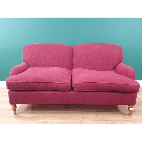 50 - A burgundy upholstered modern two-seater Sofa on turned front supports, 5ft 8in W (R9)