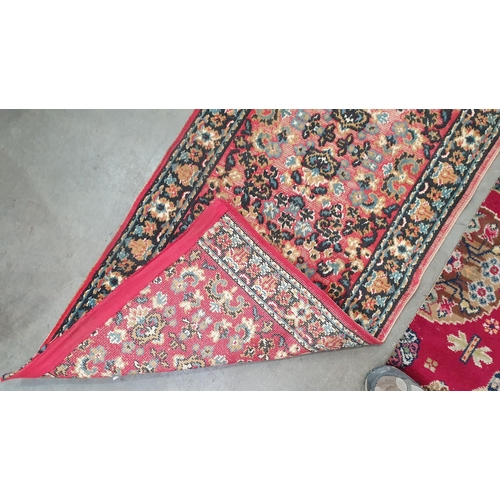 54 - A small Persian Rug with three oval medallions on a pale red ground, 5ft 3in x 3ft 9in two floral Ru... 