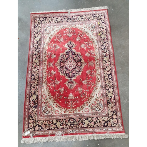 56 - A small cotton Rug, with floral borders and central floral medallion on a red ground, 4ft 9in x 3ft ... 