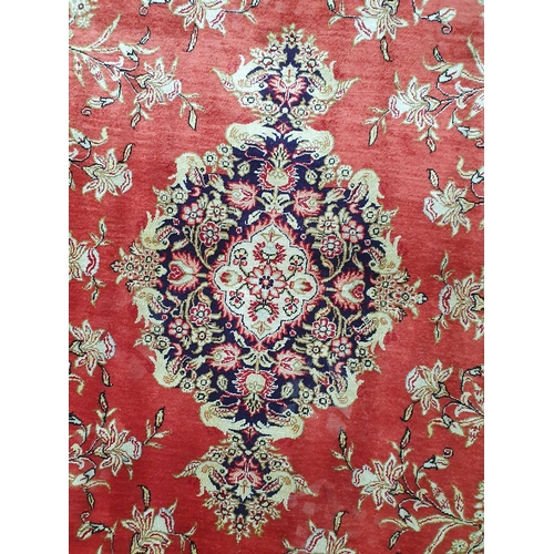 56 - A small cotton Rug, with floral borders and central floral medallion on a red ground, 4ft 9in x 3ft ... 