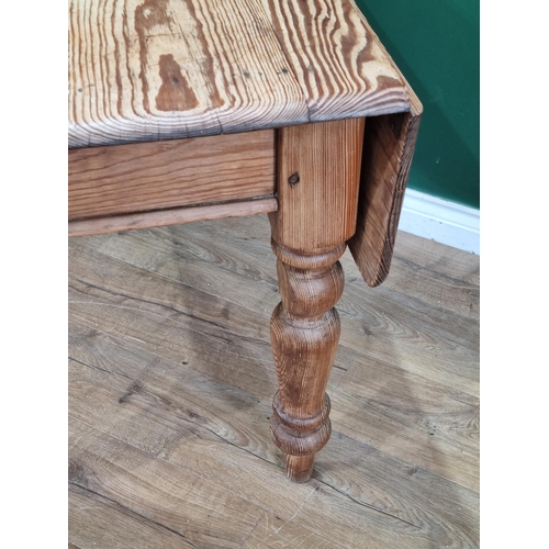 588 - A small pitch pine dropleaf Kitchen Table with single fitted drawer on turned supports, 29