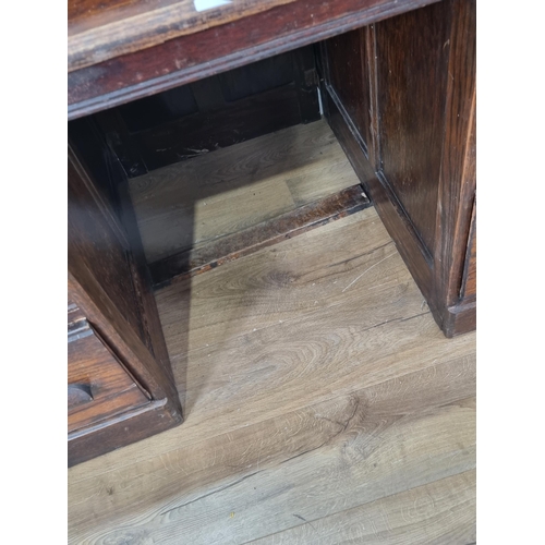 589 - A stained oak Rolltop Desk with raised metal gallery above tambour front, the pedestals fitted six d... 