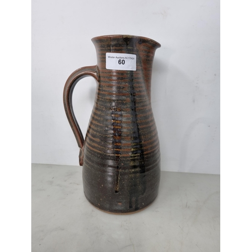 60 - Five Art Pottery Jugs with dark brown glazes, one with wheatear and leafage design, one by Leach wit... 