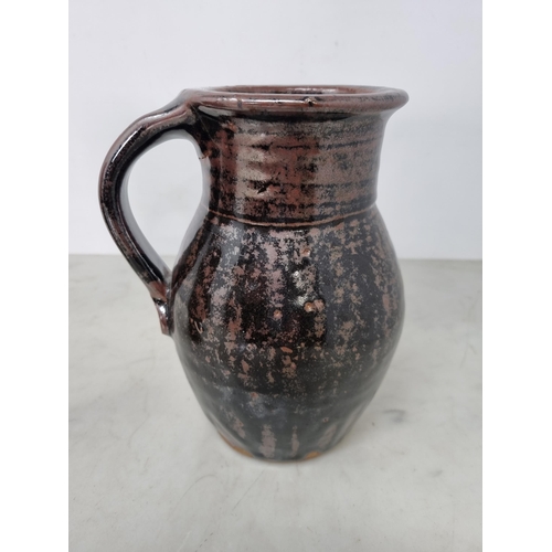 60 - Five Art Pottery Jugs with dark brown glazes, one with wheatear and leafage design, one by Leach wit... 