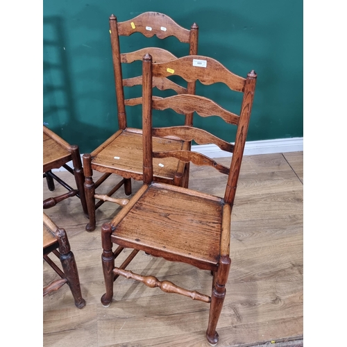 609 - A pair of ash and elm country ladderback Chairs on solid seats, shaped supports and stretchers and a... 