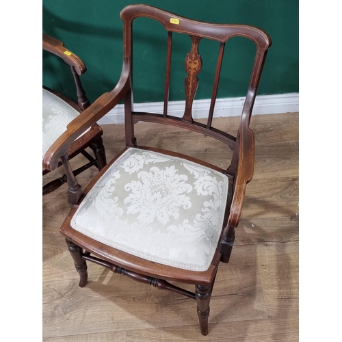 613 - A pair of mahogany Elbow Chairs with satinwood inlay decoration, with cream floral upholstered seats... 