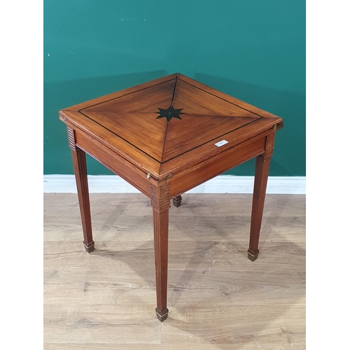 661 - A mahogany Envelope Games Table with swivel top, with central star decoration, raised on square tape... 