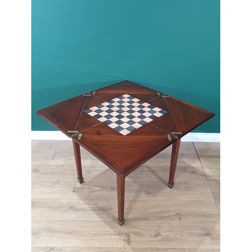 661 - A mahogany Envelope Games Table with swivel top, with central star decoration, raised on square tape... 