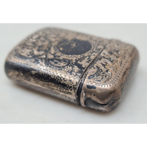 694 - An antique silver Vesta Case with engraved floral design