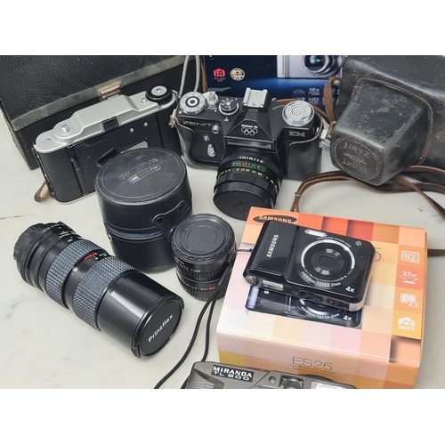 695 - A box of Film and Digital Cameras, Lenses and Photographic Accessories