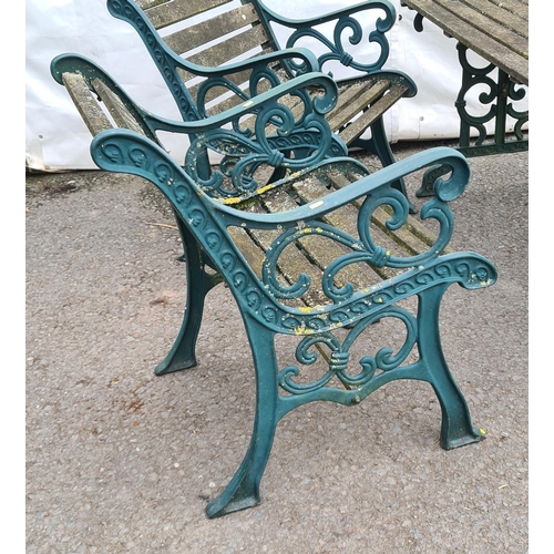 71 - A green painted cast and slatted Garden Set comprising of two-seater Bench, a Table and pair of Chai... 