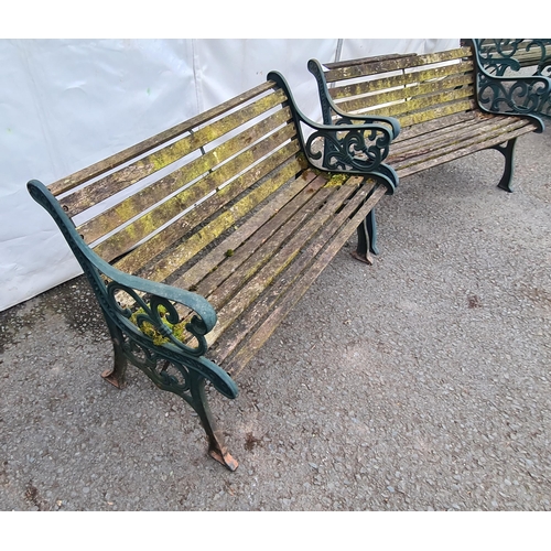 72 - A pair of green painted cast wooden slatted Garden Benches on decorative supports, A/F (Top Rail on ... 