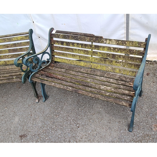 72 - A pair of green painted cast wooden slatted Garden Benches on decorative supports, A/F (Top Rail on ... 