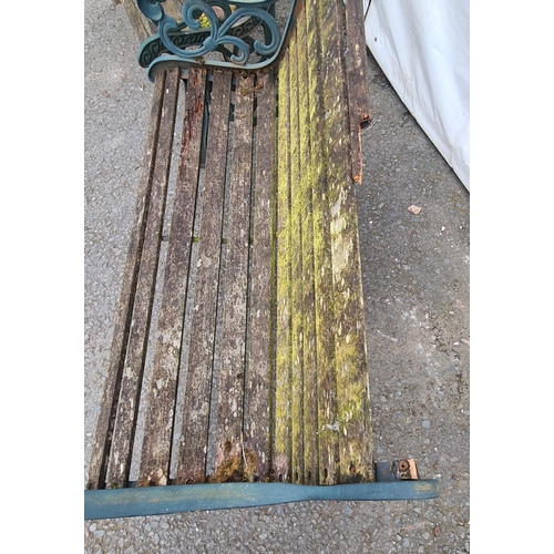 72 - A pair of green painted cast wooden slatted Garden Benches on decorative supports, A/F (Top Rail on ... 