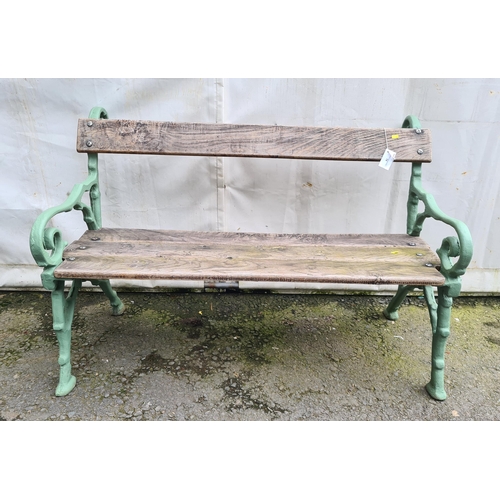 74 - A cast iron and wooden Garden Bench on rustic scrolled branch supports, 4ft 2in L