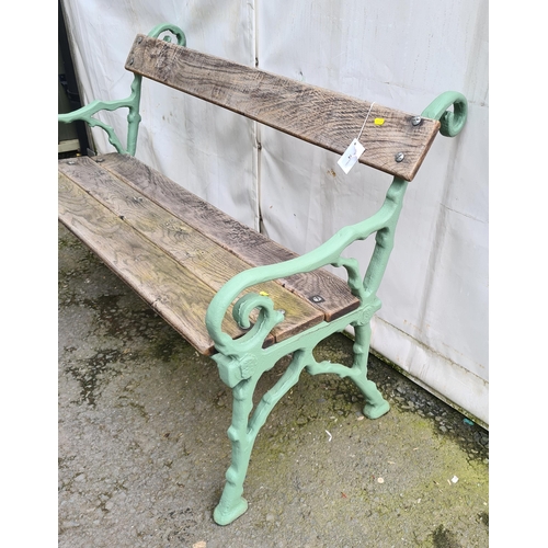 74 - A cast iron and wooden Garden Bench on rustic scrolled branch supports, 4ft 2in L