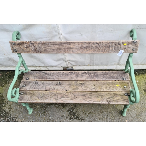 74 - A cast iron and wooden Garden Bench on rustic scrolled branch supports, 4ft 2in L