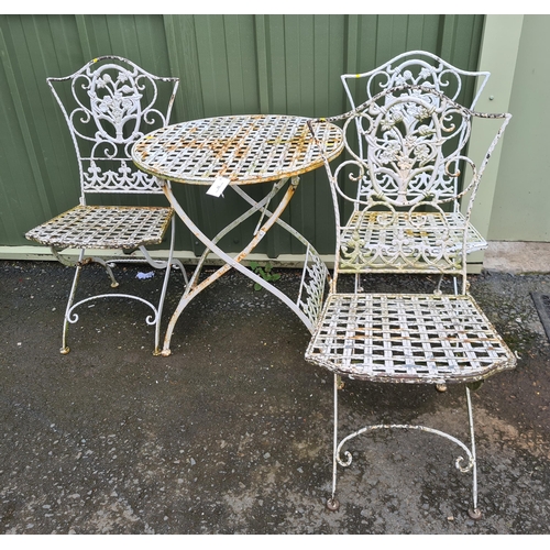 77 - A white painted metal folding Bistro Set comprising of three floral decorated Chairs with circular f... 