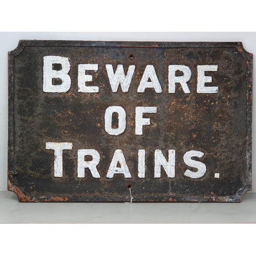 1123 - A cast iron 'BEWARE OF TRAINS' Sign 21in W x 14in H