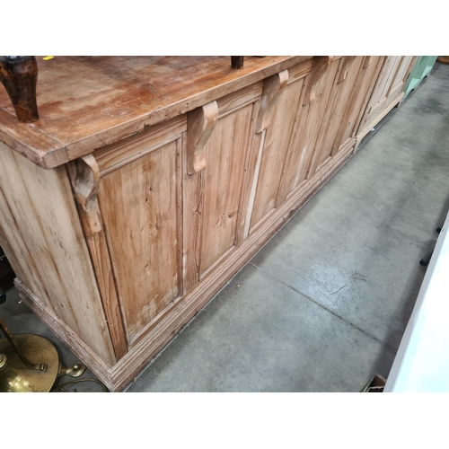 18 - A pine Shop Counter with mahogany top above six panel front, raised on moulded plinth base, 3ft High... 