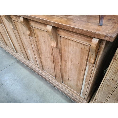 18 - A pine Shop Counter with mahogany top above six panel front, raised on moulded plinth base, 3ft High... 