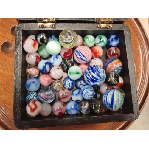 385 - A Solitaire Board and a box containing marbles including some old marbles