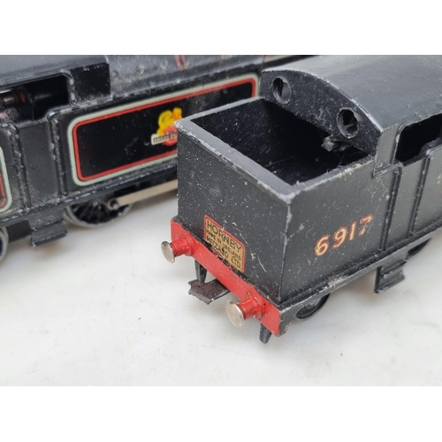 1075 - Two unboxed Hornby Dublo 3-rail 0-6-2T Locomotives, one in LMS black and the other in BR gloss black... 