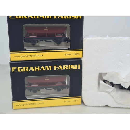 1112 - Three boxed Graham Farish N gauge EWS Hopper Wagons and a Hornby 00 gauge Low-loader Wagon