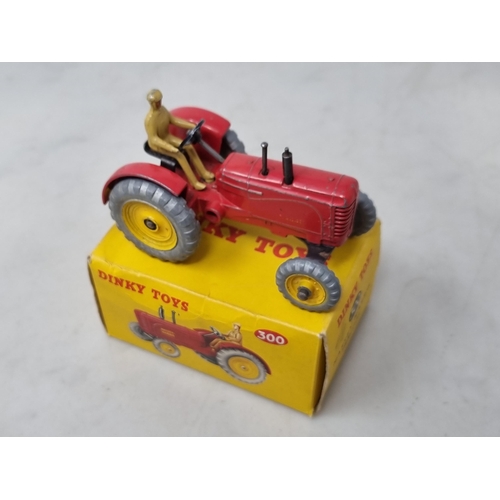 1324 - A boxed Dinky Toys No.300 Massey-Harris Tractor, G (transfers heavily worn), box Ex