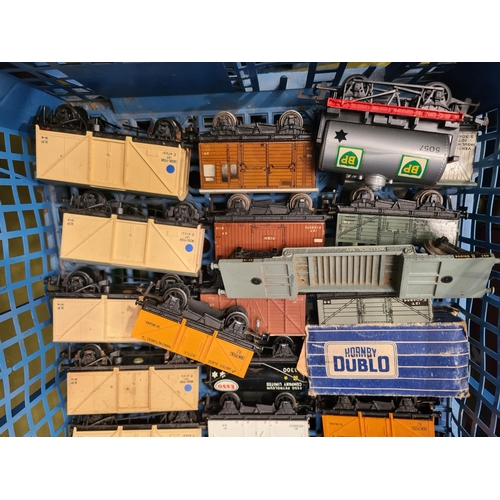 1099 - Two trays containing twenty unboxed Hornby Dublo and Trix Wagons and a S.R. Suburban Trailer Coach i... 