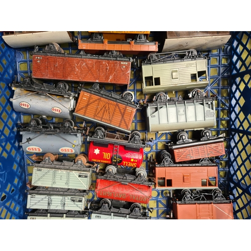 1099 - Two trays containing twenty unboxed Hornby Dublo and Trix Wagons and a S.R. Suburban Trailer Coach i... 