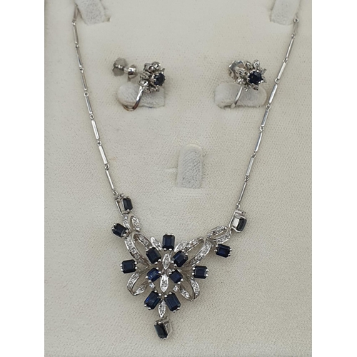 166 - A Sapphire and Diamond Necklace the front with openwork ribbon effect plaque claw-set step-cut sapph... 