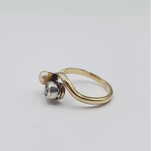 173 - A Diamond and cultured Pearl Crossover Ring rubover-set single brilliant-cut diamond next to single ... 