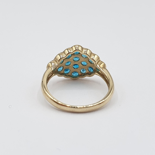 176 - A Cluster Ring having lozenge shaped plaque set round stones, possibly apatite, in 9ct gold, ring si... 