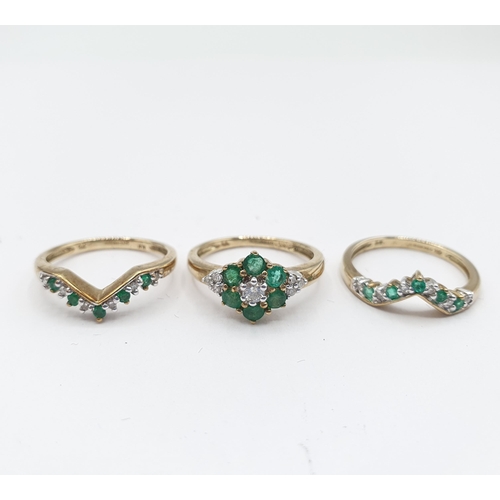 177 - A Diamond and Emerald Trio Ring the principle cluster Ring claw-set brilliant-cut diamond within a f... 