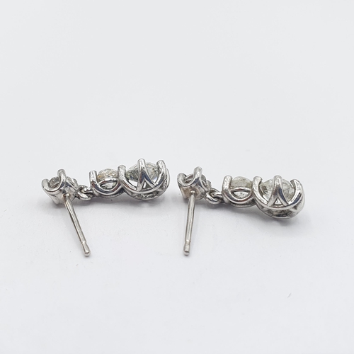 185 - A pair of diamond drop Earrings each claw-set three graduated old-cut stones in platinum, estimated ... 