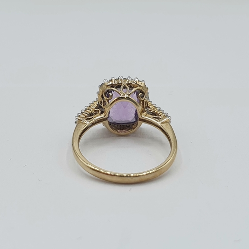 187 - An Amethyst and Diamond Cluster Ring set cushion shaped amethyst within a frame of eight-cut diamond... 