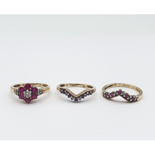 188 - A Diamond and Ruby Ring Trio the principle cluster Ring claw-set brilliant-cut diamond within six ro... 