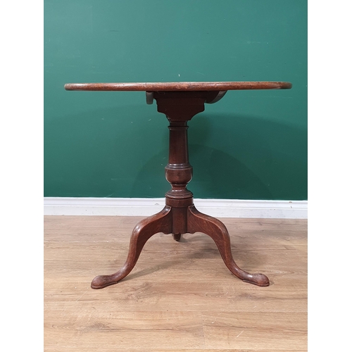 1 - An antique mahogany tilt top Tripod Table on turned column and shaped supports, A/F, 2ft 4