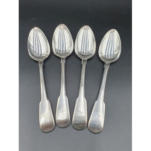 101 - Four George III silver Table Spoons fiddle pattern engraved crests, London 1818, maker: W.B