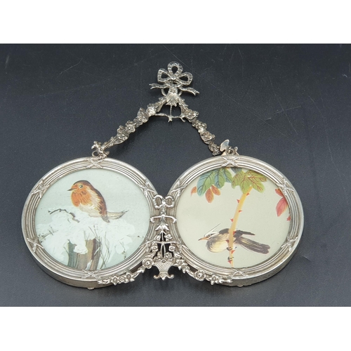 107 - An Edward Vii silver double Photograph Frame with ribbon and floral surmount, London 1908, slight da... 