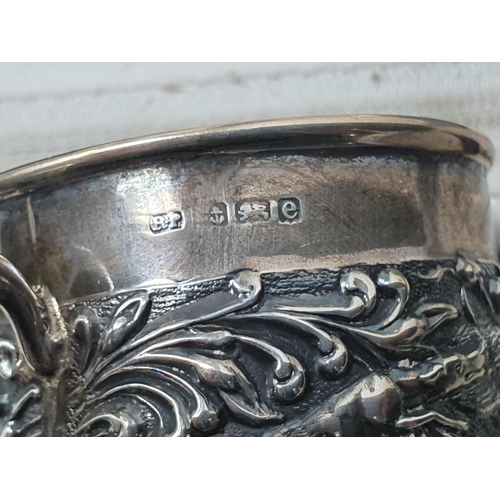 108 - An Edward VII small Mug embossed dogs and scrolls, Birmingham 1904, and an embossed lobed circular D... 