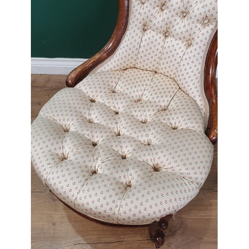 13 - A button upholstered Nursing Chair with carved scroll decoration, with cream and floral pattern upho... 