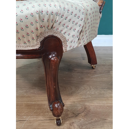 13 - A button upholstered Nursing Chair with carved scroll decoration, with cream and floral pattern upho... 