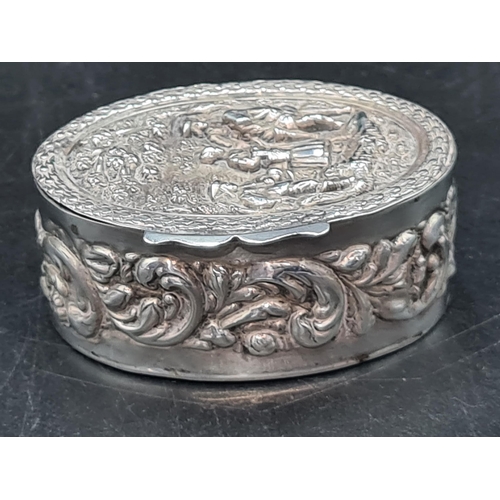 134 - An Edward VII silver oval Box embossed and chased three figures in a landscape, Birmingham 1901