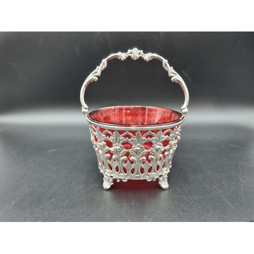 146 - A Victorian silver circular Basket with leafage pierced frieze, swing handle and shaped frieze, pink... 